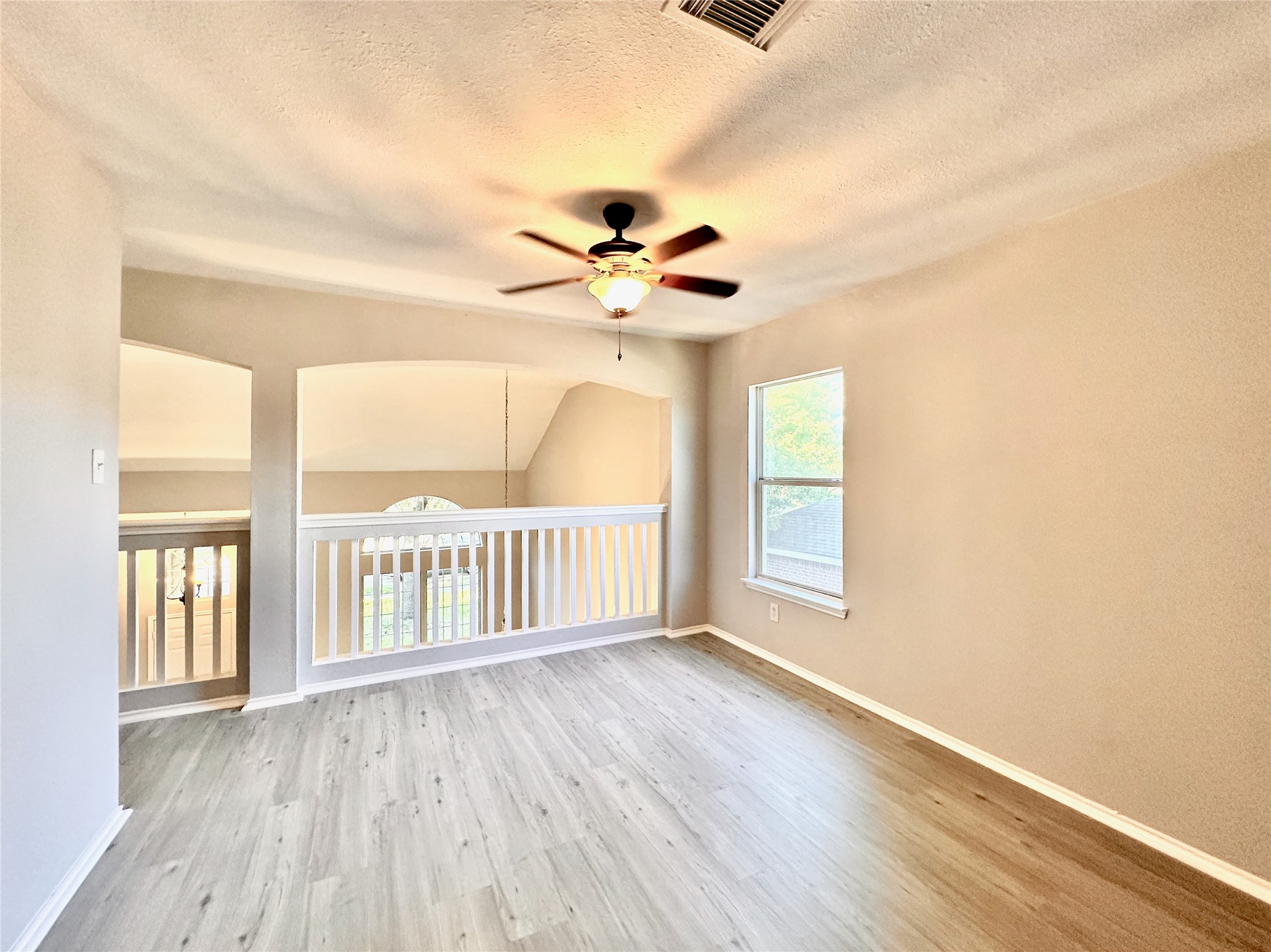 3042 Trinity Pass Court Spring, TX 77373 - Photo 19 of 34 an empty room with wooden floor and windows