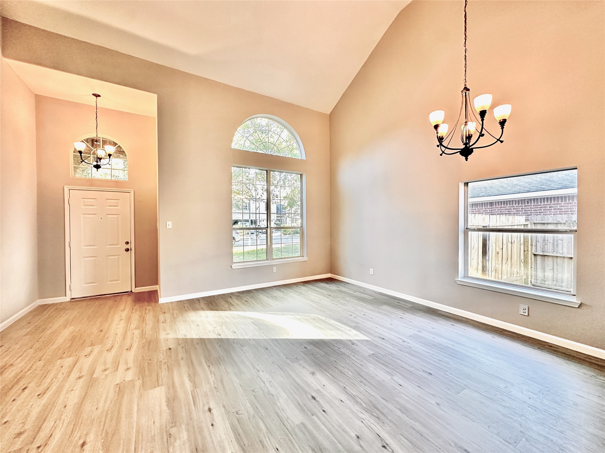 3042 Trinity Pass Court Spring, TX 77373 - Photo 2 of 34 an empty room with wooden floor chandelier and windows