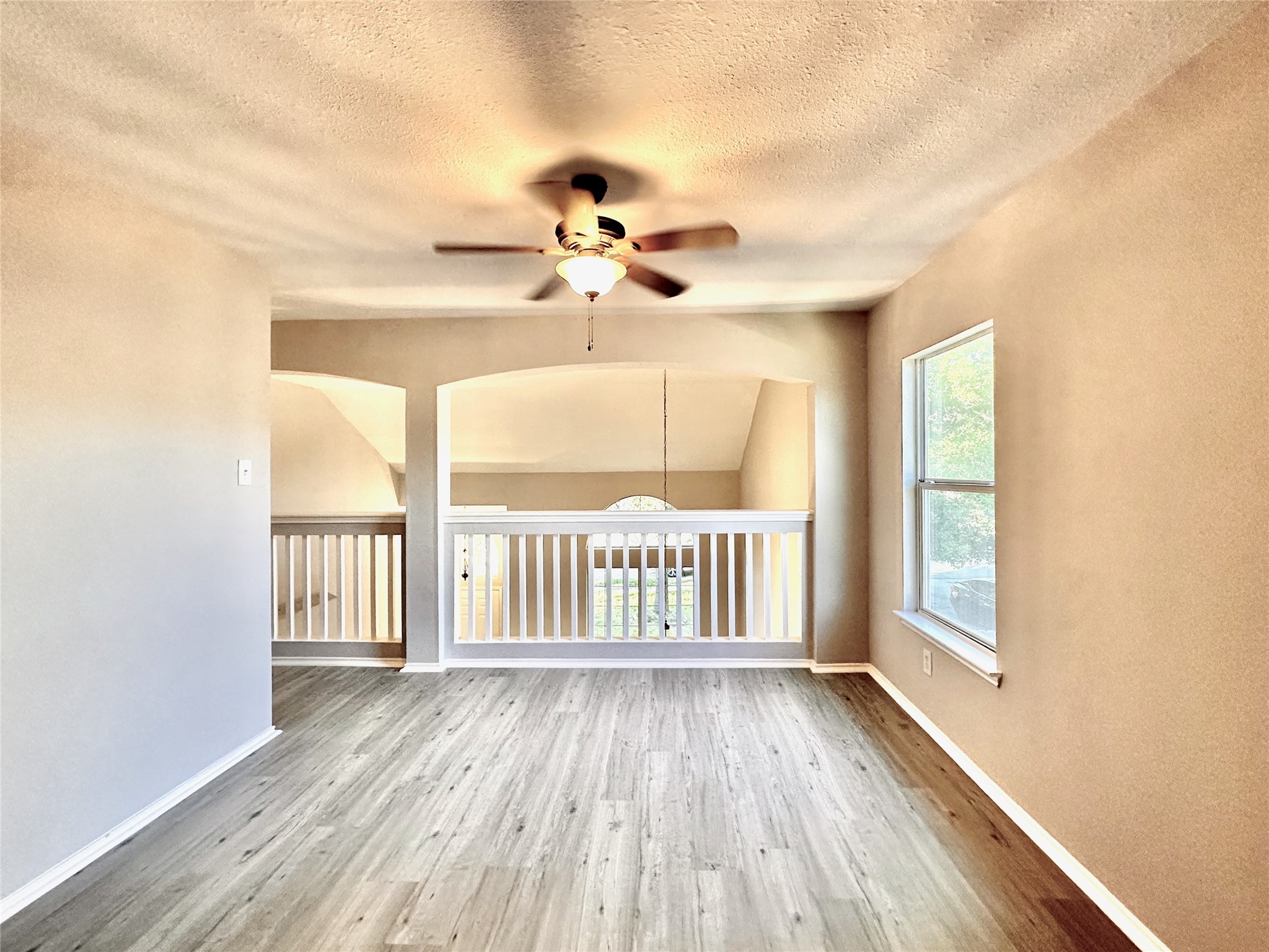 3042 Trinity Pass Court Spring, TX 77373 - Photo 21 of 34 a view of a livingroom with wooden floor and a ceiling fan