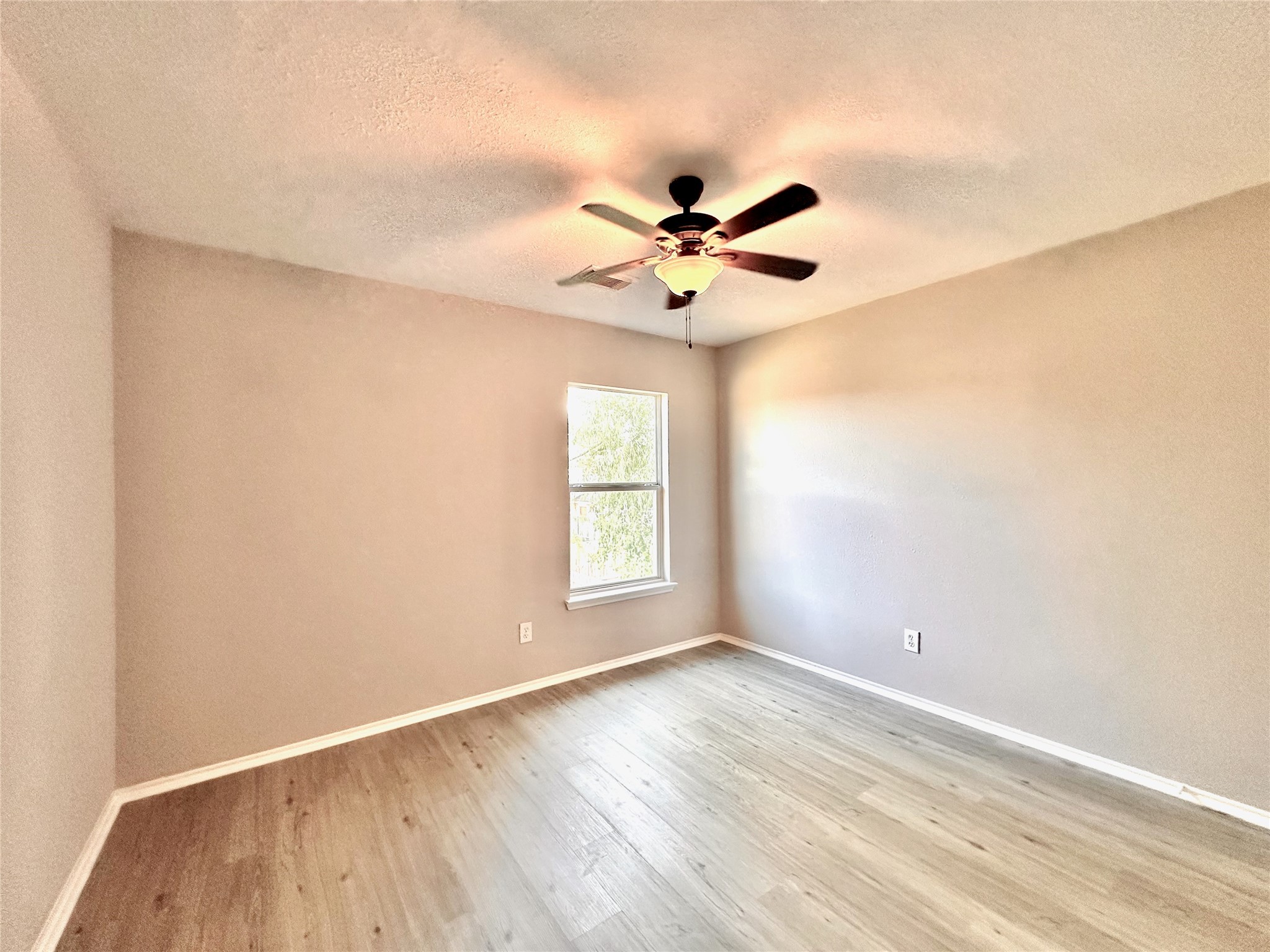 3042 Trinity Pass Court Spring, TX 77373 - Photo 22 of 34 a view of empty room with wooden floor and fan