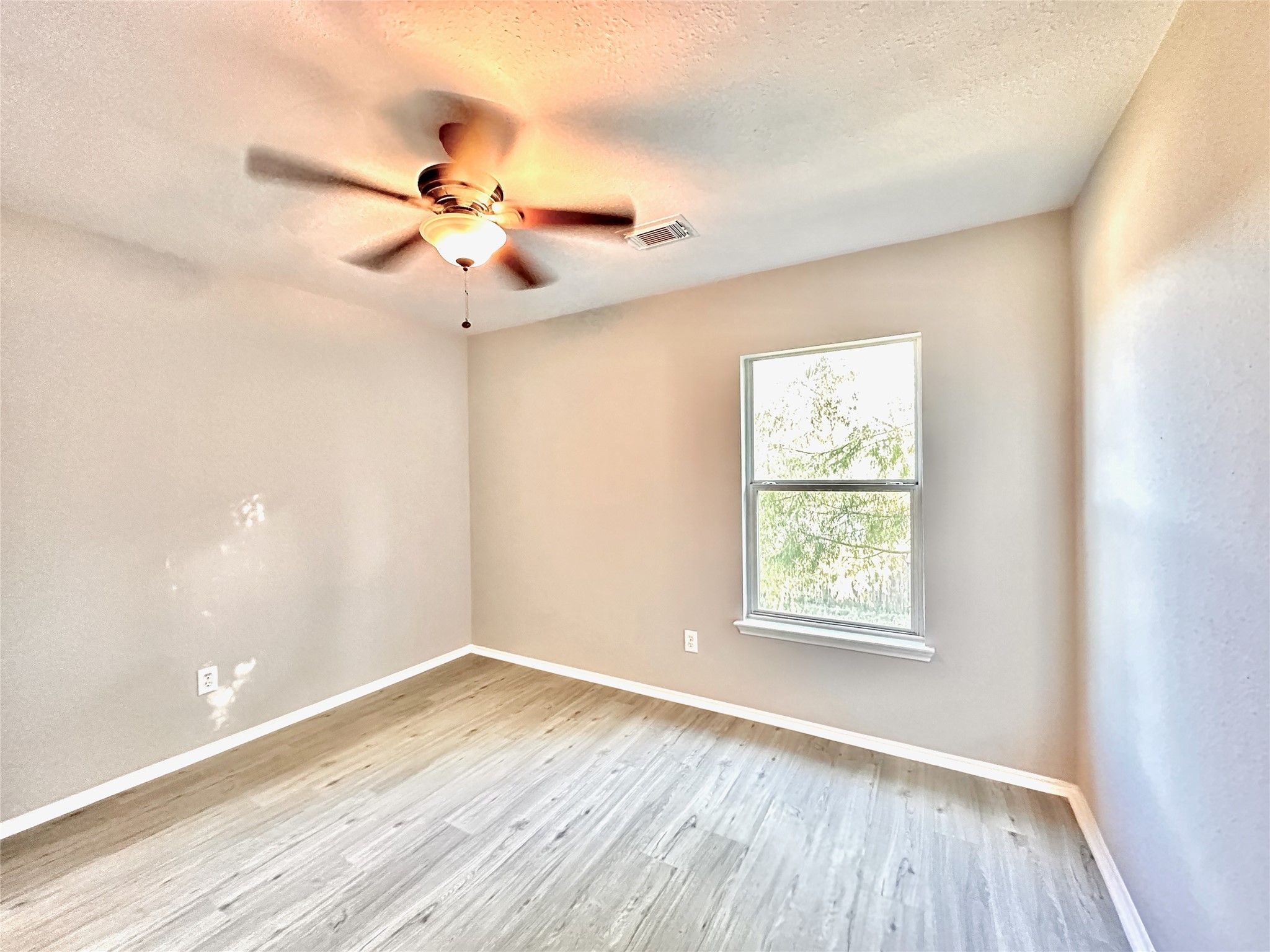 3042 Trinity Pass Court Spring, TX 77373 - Photo 23 of 34 wooden floor in an empty room with a window