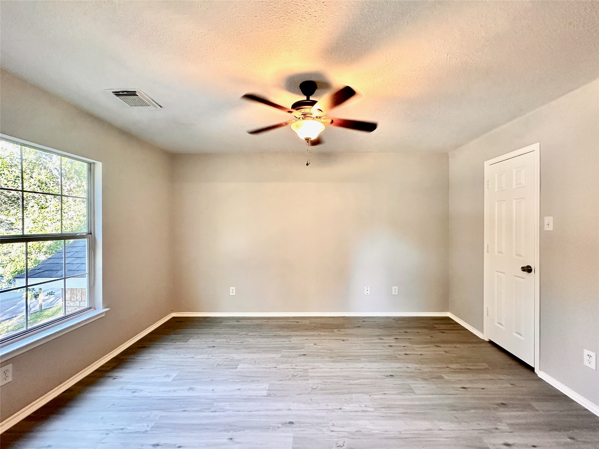 3042 Trinity Pass Court Spring, TX 77373 - Photo 28 of 34 wooden floor in an empty room with a window