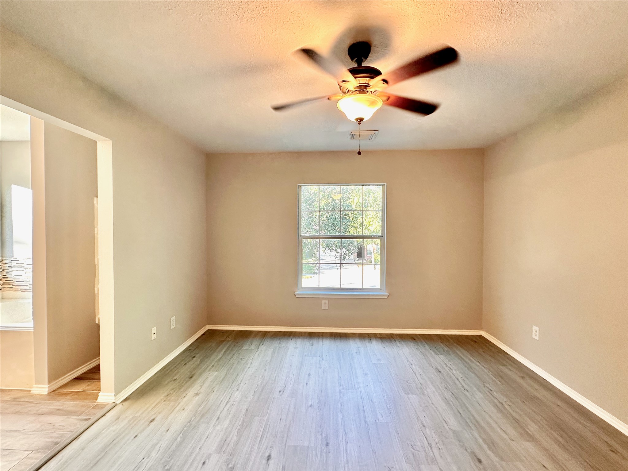 3042 Trinity Pass Court Spring, TX 77373 - Photo 29 of 34 a view of an empty room with wooden floor and a window