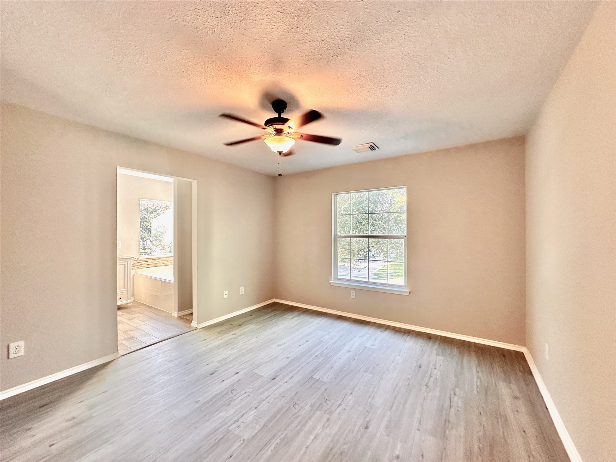 3042 Trinity Pass Court Spring, TX 77373 - Photo 30 of 34 a view of an empty room with a window and wooden floor