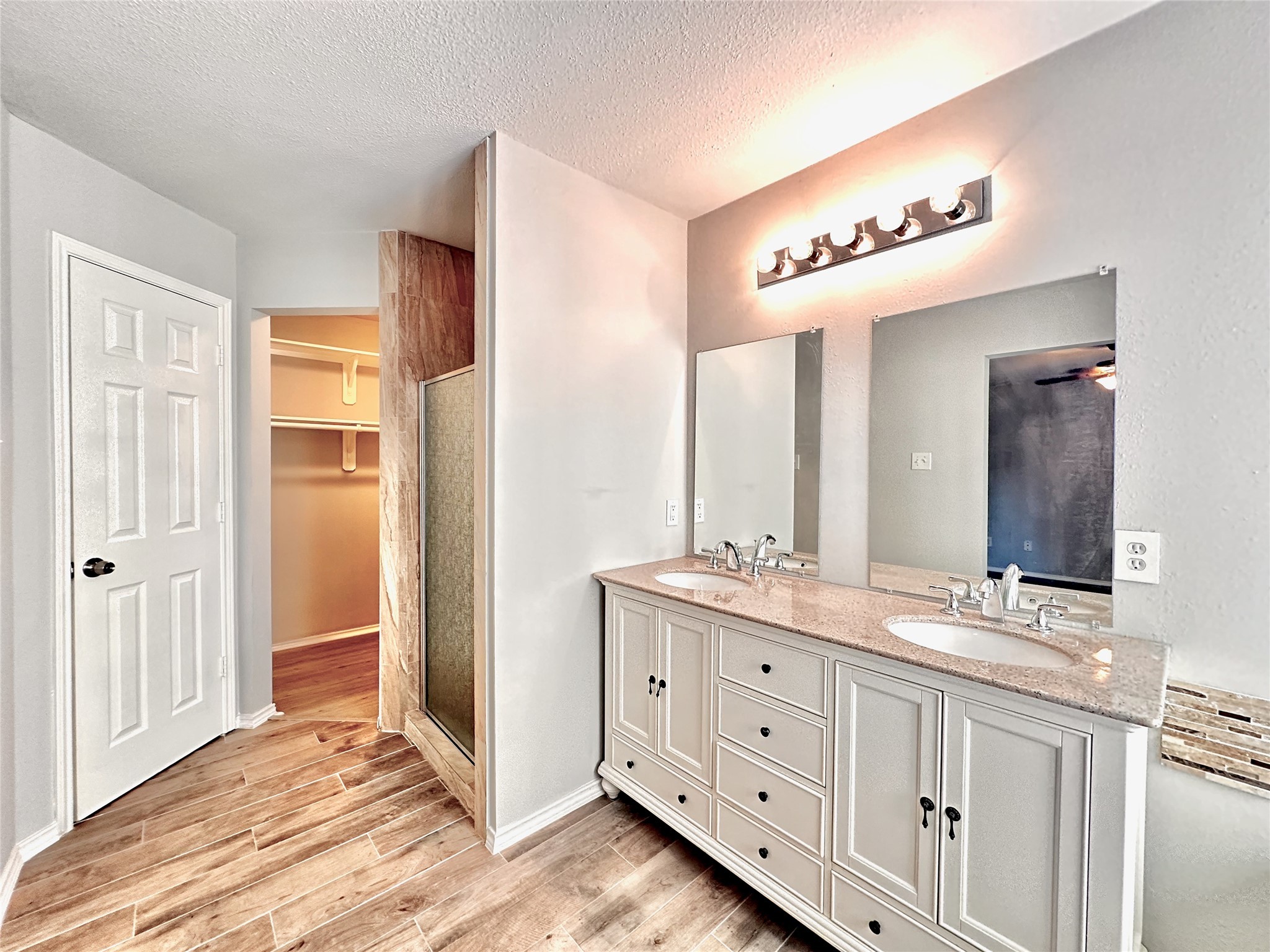 3042 Trinity Pass Court Spring, TX 77373 - Photo 31 of 34 a spacious bathroom with a double vanity sink and a mirror