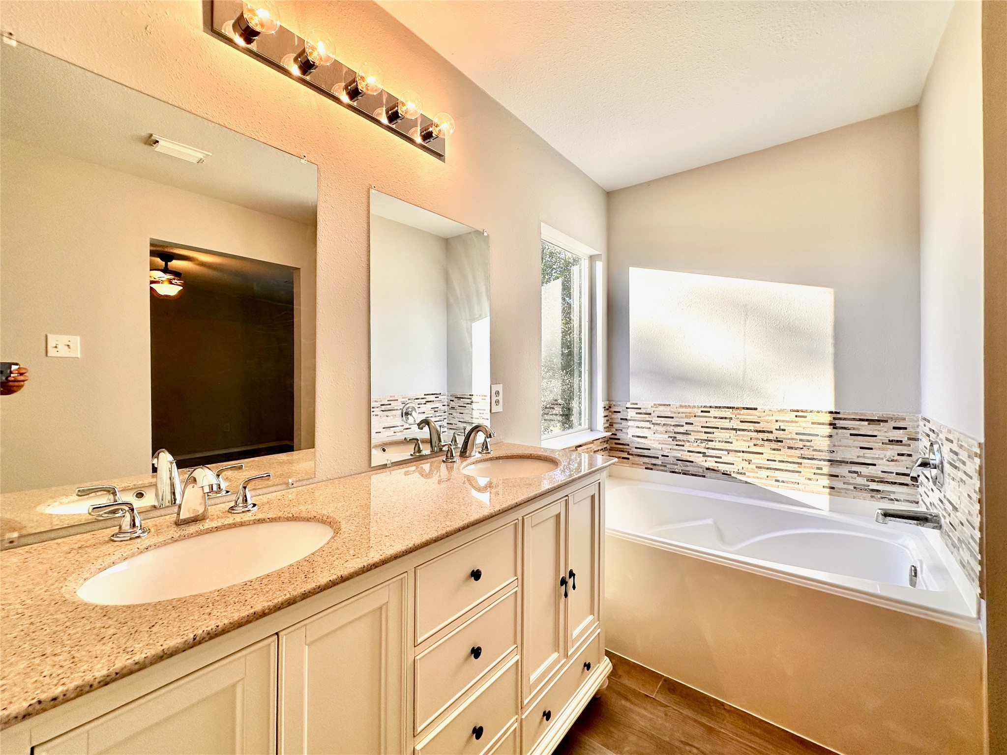 3042 Trinity Pass Court Spring, TX 77373 - Photo 32 of 34 a bathroom with a granite countertop sink and a mirror