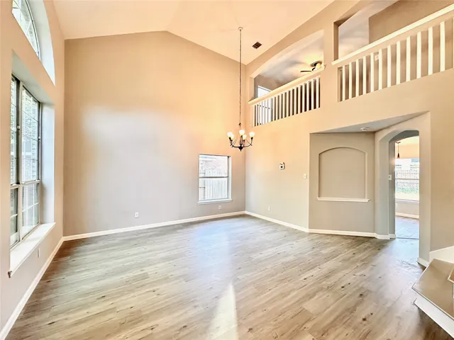 a view of a bedroom with wooden floor and front door