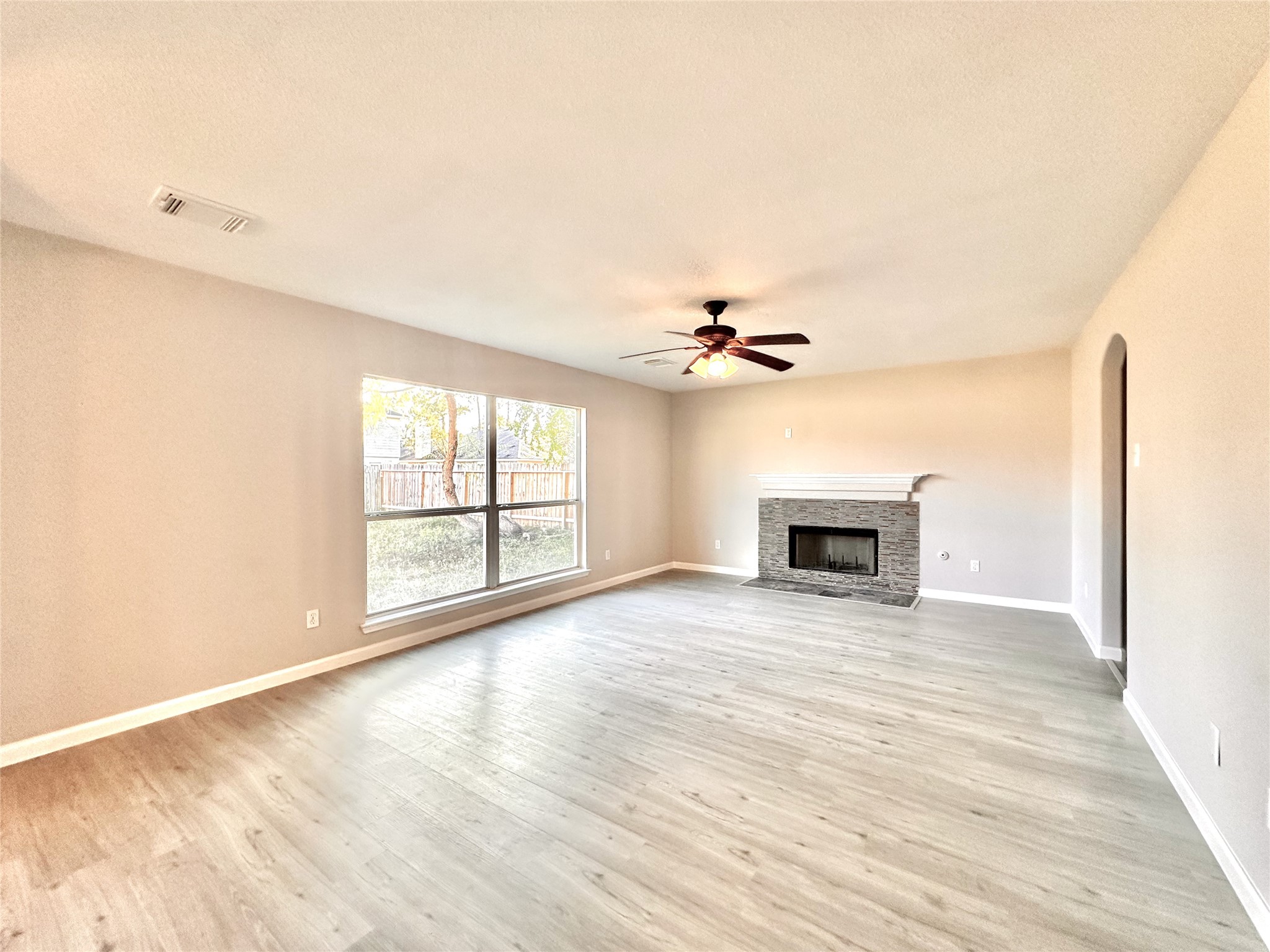 3042 Trinity Pass Court Spring, TX 77373 - Photo 10 of 34 a view of an empty room with a fireplace and a window