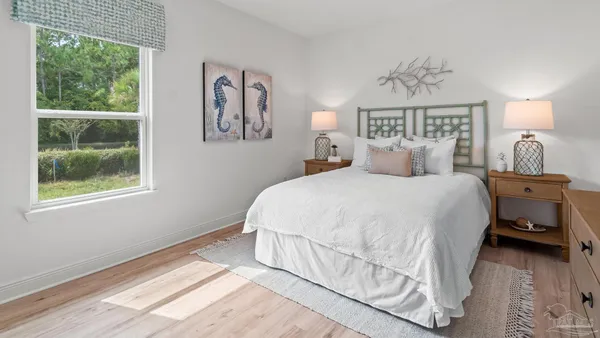 a bedroom with a bed and a painting on the wall