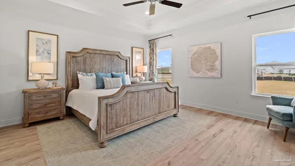 a bedroom with a bed a couch and dresser