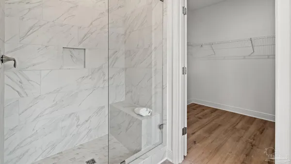 a bathroom with a glass shower door