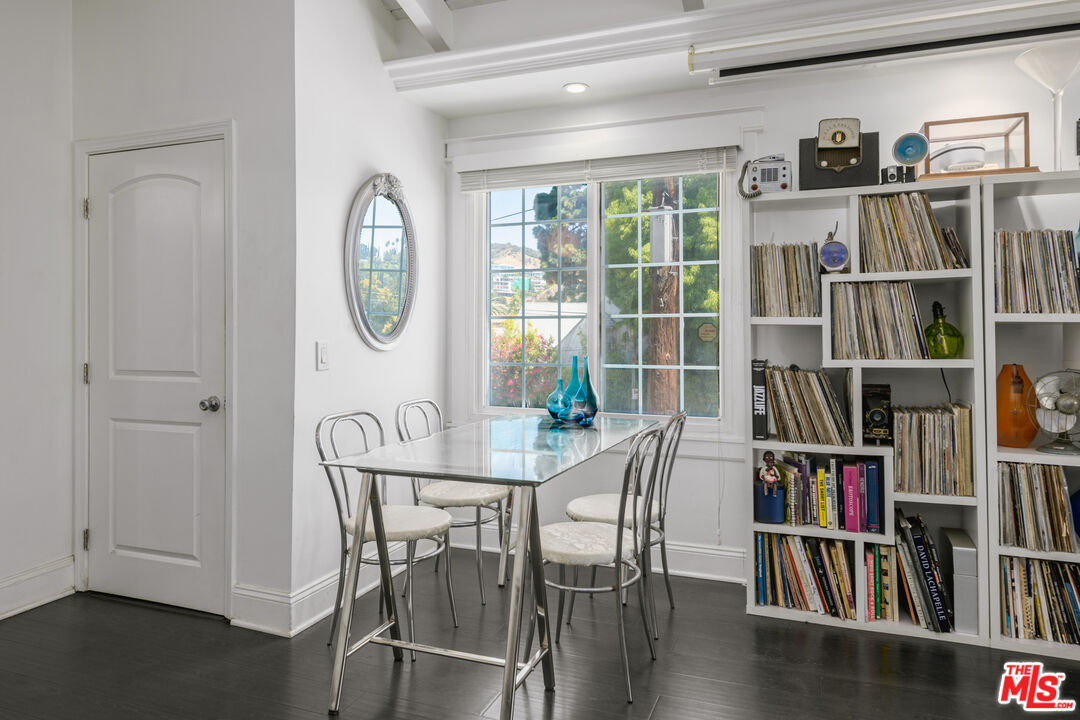 2225 North Cahuenga Boulevard Los Angeles, CA 90068 - Photo 14 of 30 a dining room with furniture a book and book shelf