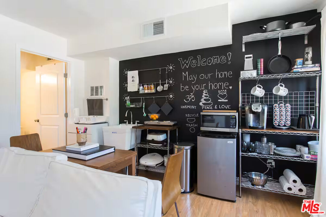2225 North Cahuenga Boulevard Los Angeles, CA 90068 - Photo 24 of 30 a kitchen area with lots of counter top space and wooden floor
