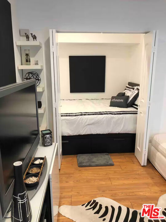 2225 North Cahuenga Boulevard Los Angeles, CA 90068 - Photo 25 of 30 a living room with a bed and a television