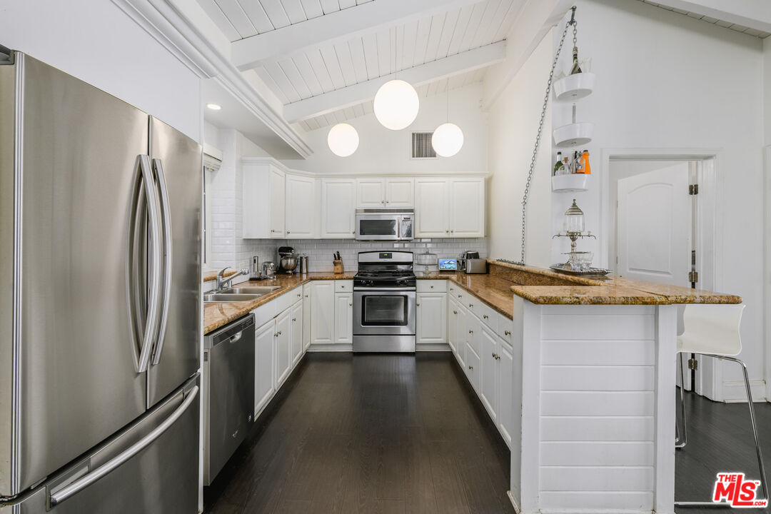 2225 North Cahuenga Boulevard Los Angeles, CA 90068 - Photo 8 of 30 a large kitchen with a refrigerator a stove and a sink