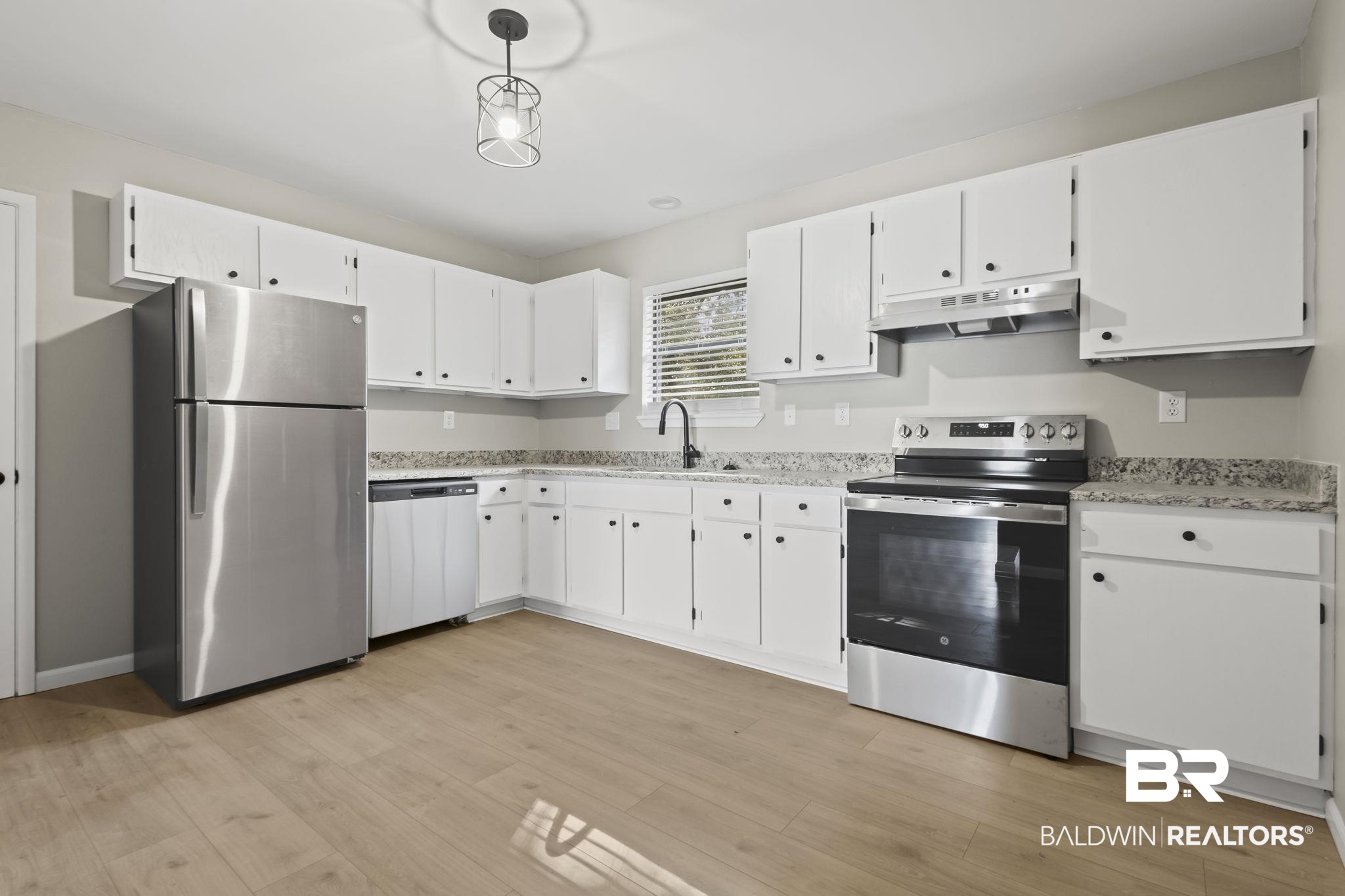 309 West Roosevelt Avenue Foley, AL 36535 - Photo 7 of 60 Kitchen with pendant lighting, white cabinets, sink, light hardwood / wood-style flooring, and stainless steel appliances