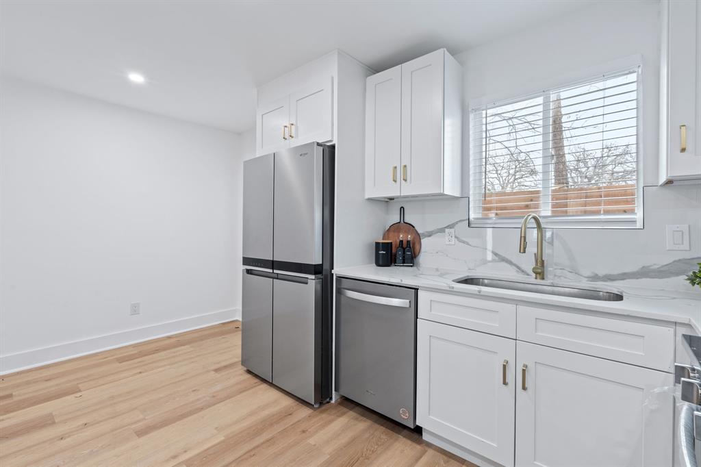 2706 Wheless Lane, Unit 401 Austin, TX 78723 - Photo 11 of 24 A well-appointed kitchen features stainless steel appliances, gleaming countertops, and light wood flooring.