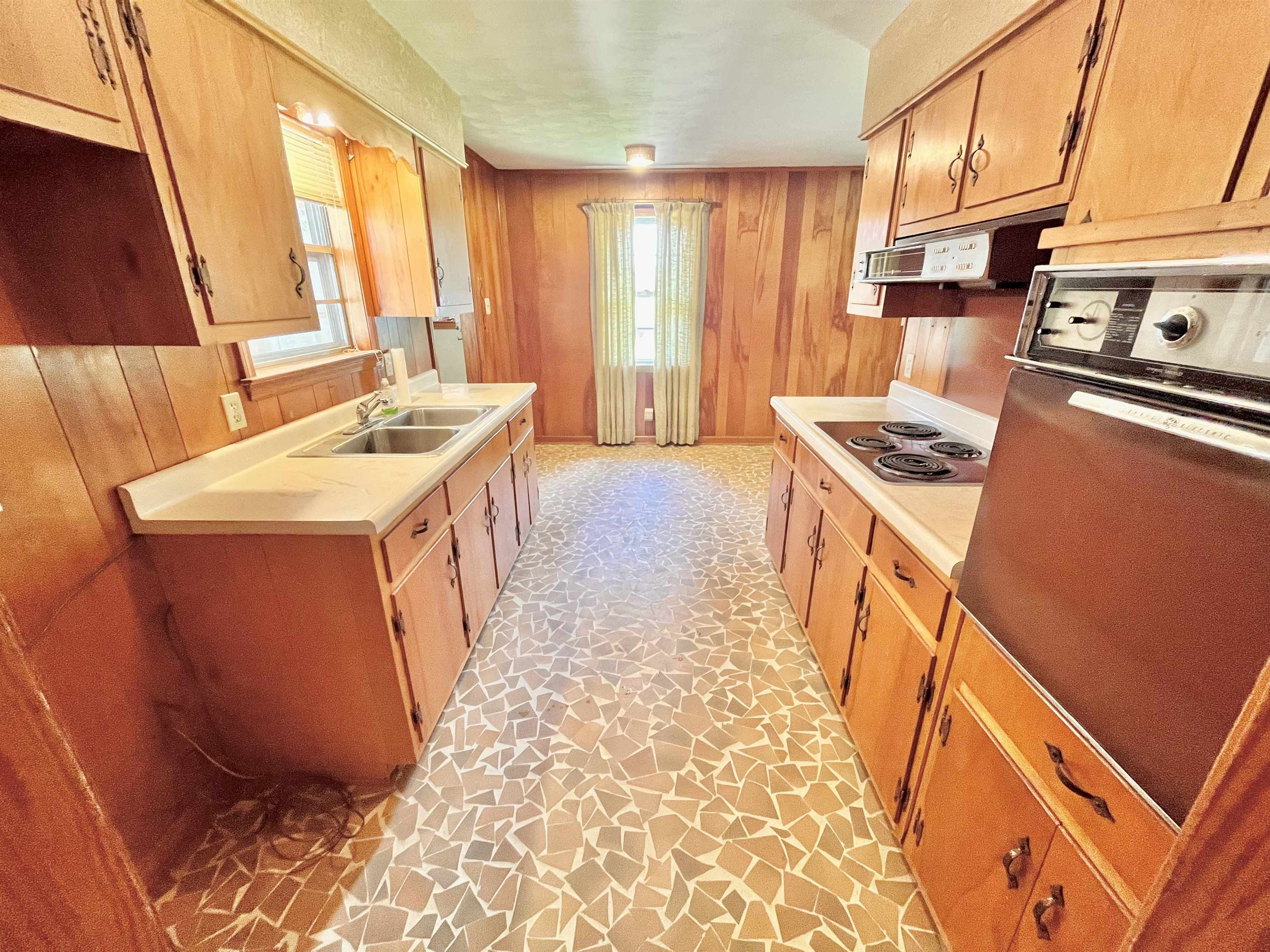 7623 Craft Road Olive Branch, MS 38654 - Photo 13 of 20 Kitchen featuring wall oven, exhaust hood, white electric stovetop, wood walls, and sink