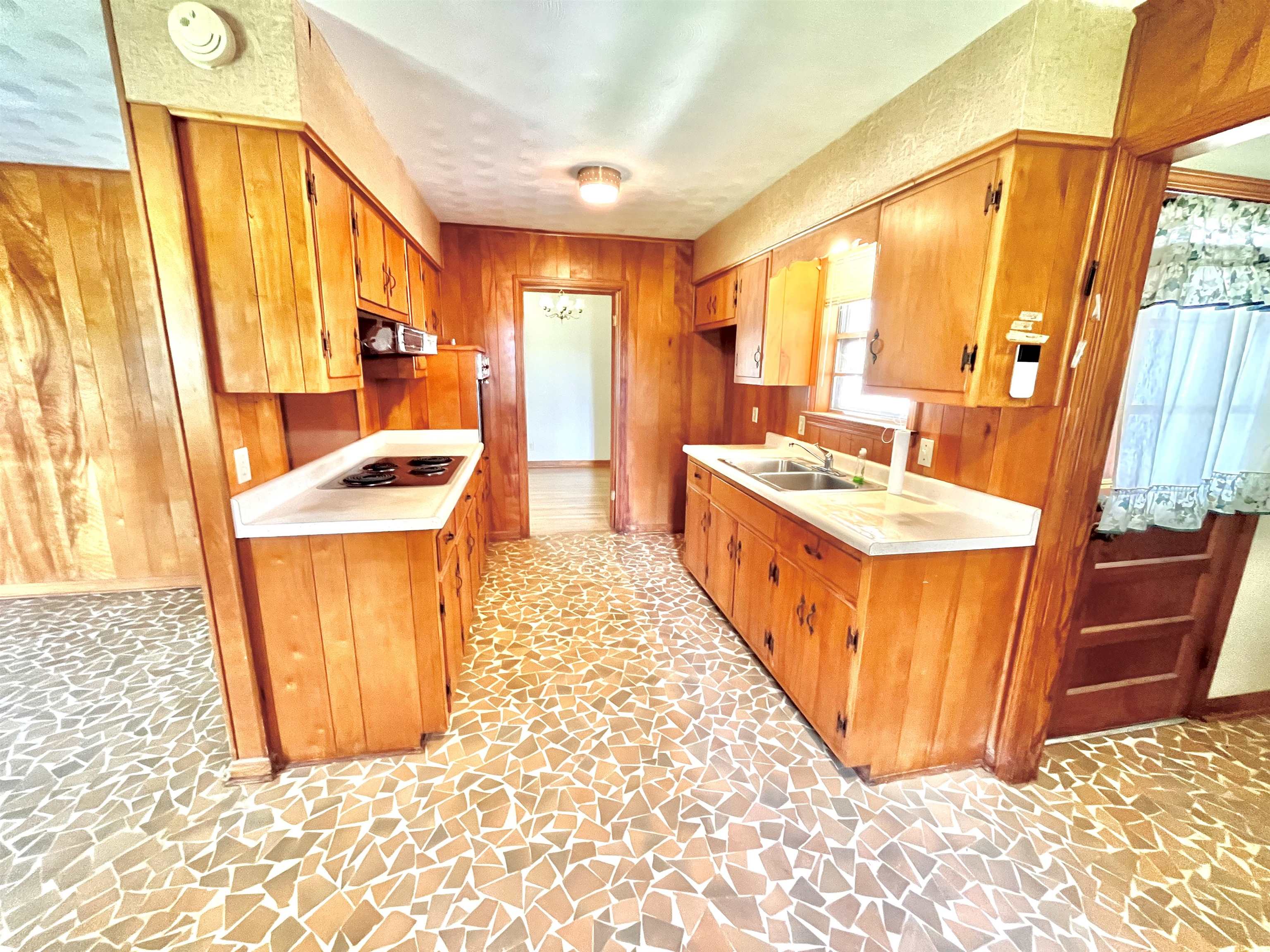7623 Craft Road Olive Branch, MS 38654 - Photo 14 of 20 Kitchen featuring sink, exhaust hood, wood walls, and electric cooktop