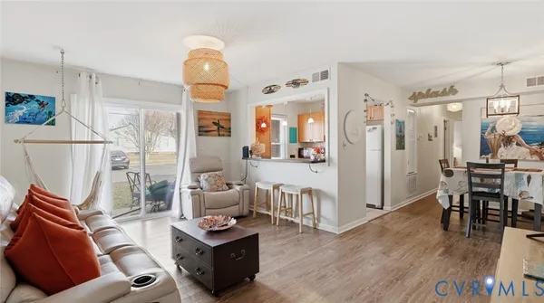 a living room with furniture and wooden floor