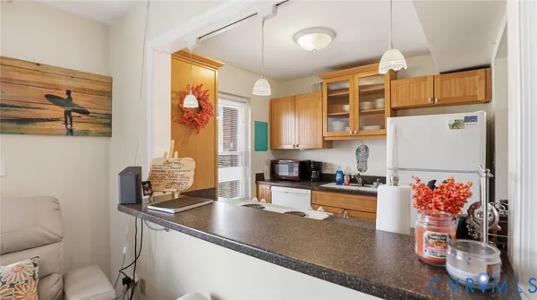 a kitchen with stainless steel appliances a sink a stove and a wooden floor