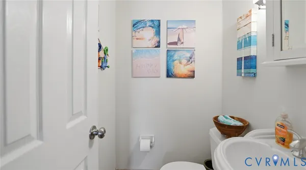 a bathroom with a toilet and a shower curtain