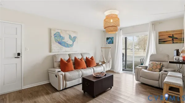 a living room with furniture and wooden floor