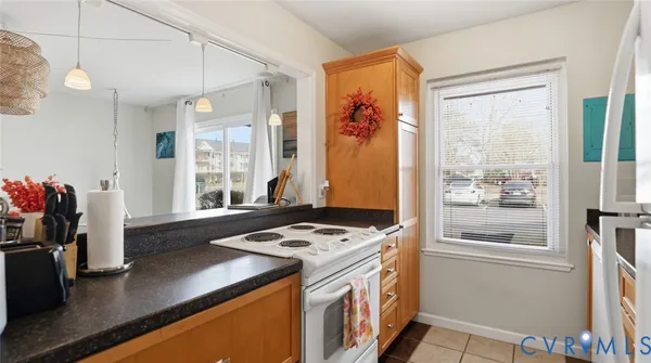 a kitchen with a refrigerator a stove and a window