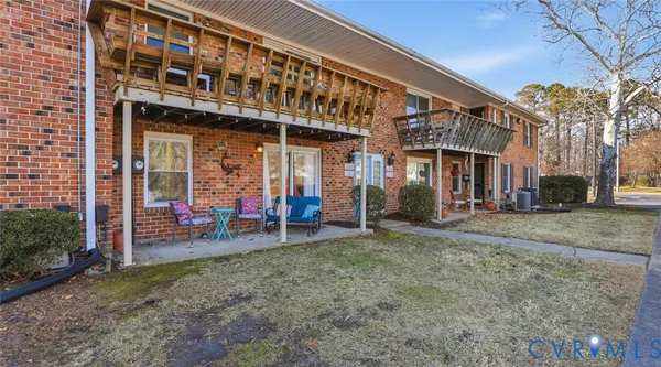 a front view of a brick house with a yard