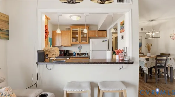a kitchen with stainless steel appliances granite countertop a sink and a refrigerator