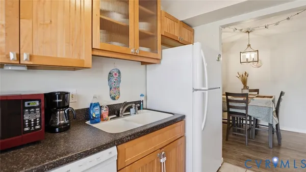 a kitchen with stainless steel appliances granite countertop a sink and a refrigerator