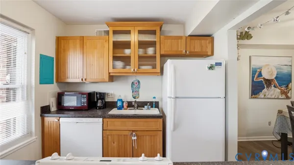 a white refrigerator freezer sitting inside of a kitchen