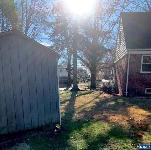 a view of a yard with wooden fence