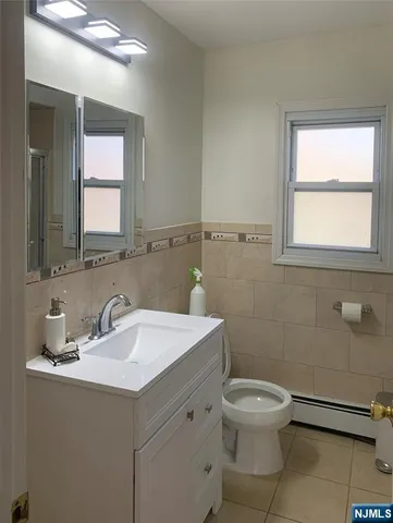 a bathroom with a sink toilet and mirror