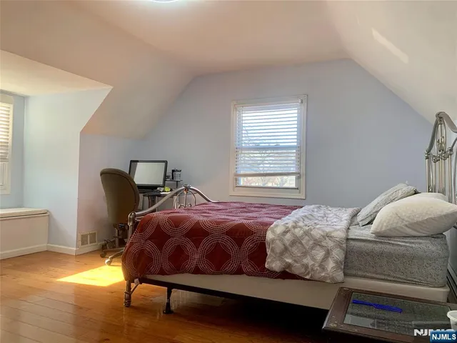 a bedroom with a bed chair and window