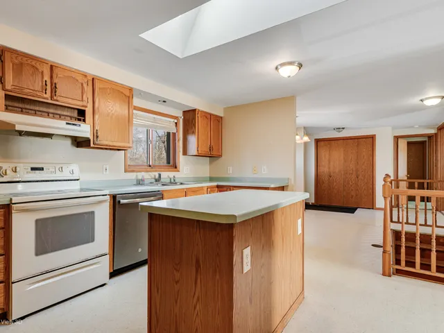an empty room with window and air conditioner vent