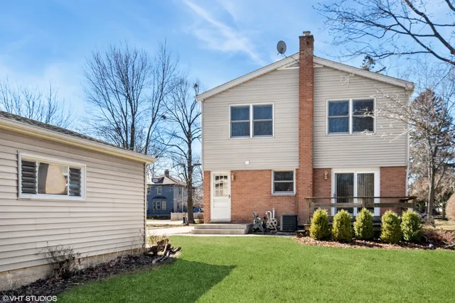 a front view of a house with a yard and outdoor seating