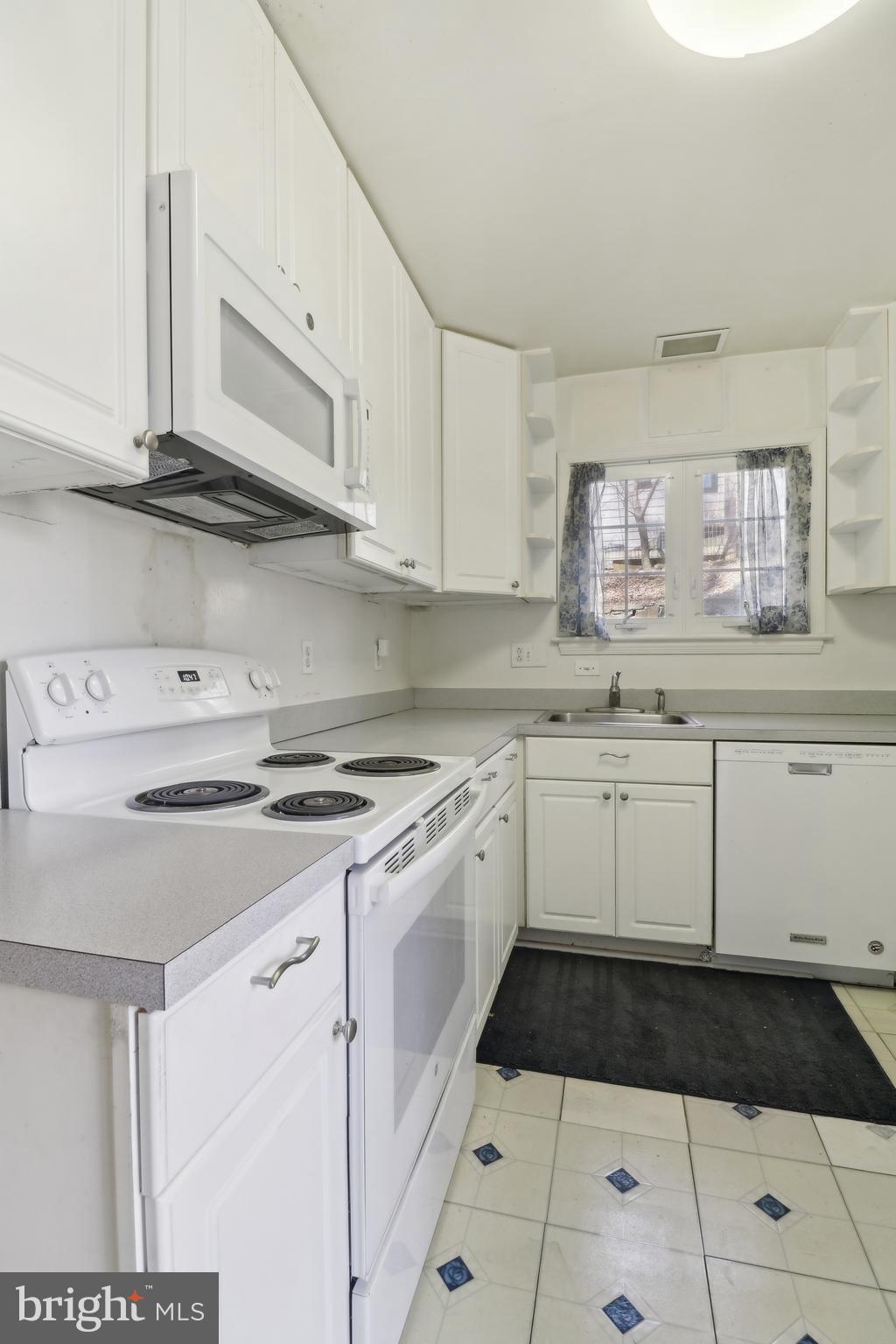 14 Park Valley Road Silver Spring, MD 20910 - Photo 17 of 63 a kitchen with granite countertop a stove a sink and cabinets