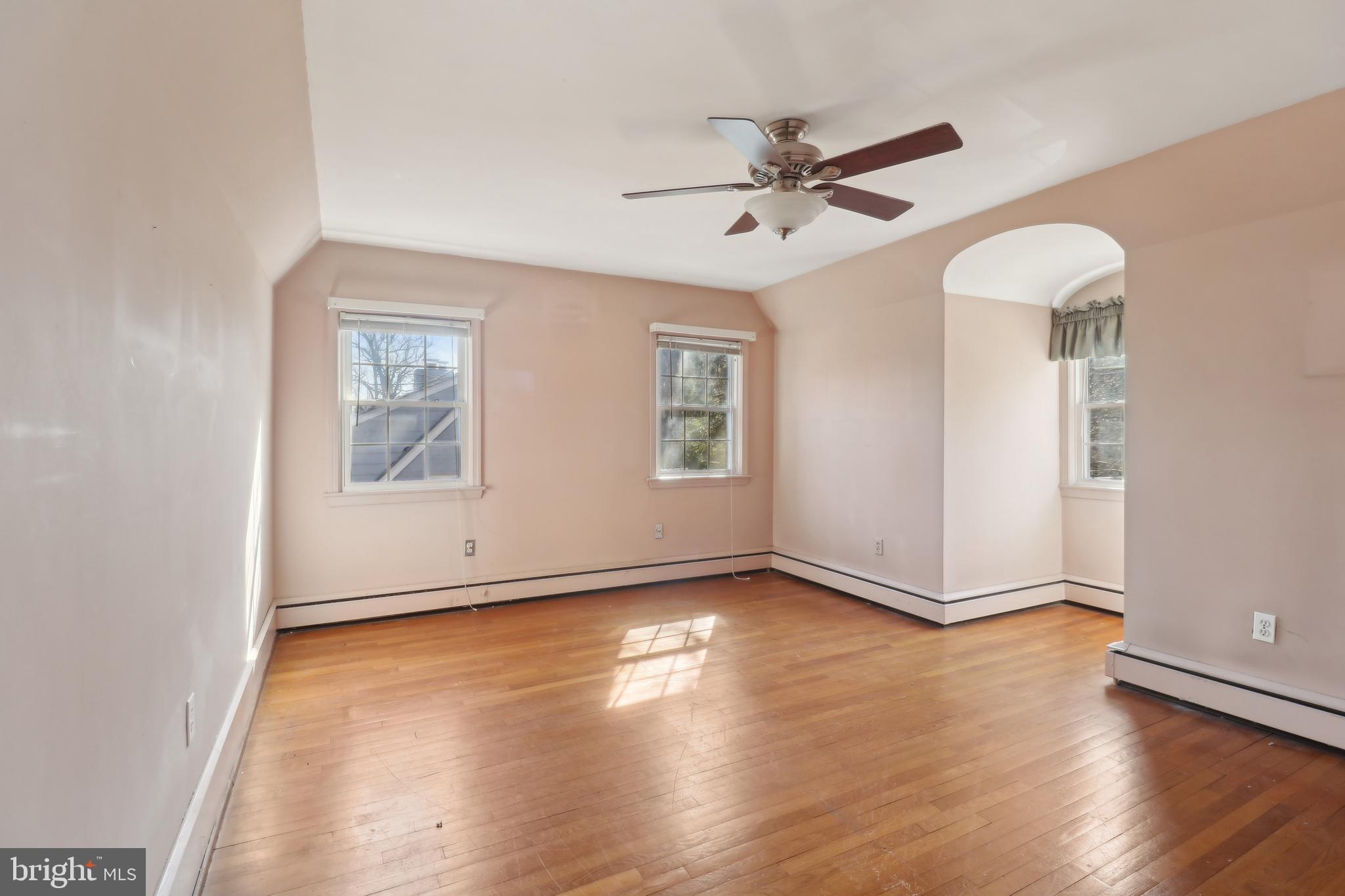14 Park Valley Road Silver Spring, MD 20910 - Photo 33 of 63 an empty room with wooden floor chandelier fan and windows