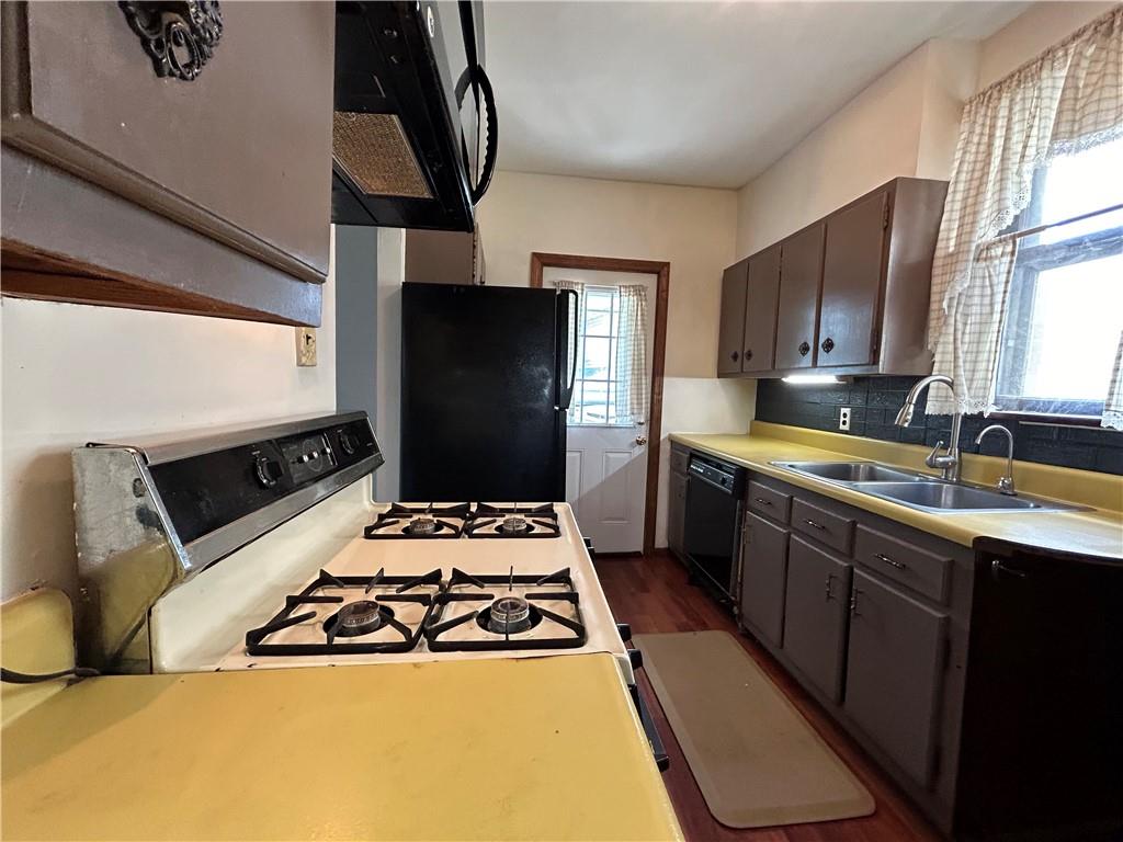 527 Carbon Street Butler, PA 16001 - Photo 7 of 19 a kitchen with stainless steel appliances a sink stove and refrigerator