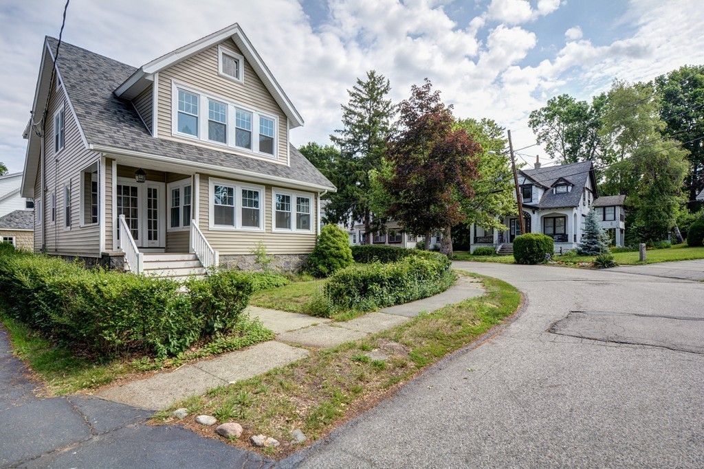 39 Willoughby Road Milton, MA 02186 - Photo 16 of 20 a front view of a house with a yard and potted plants
