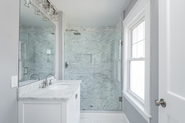 39 Willoughby Road Milton, MA 02186 - Photo 8 of 20 a bathroom with a granite countertop sink a mirror a window and a shower