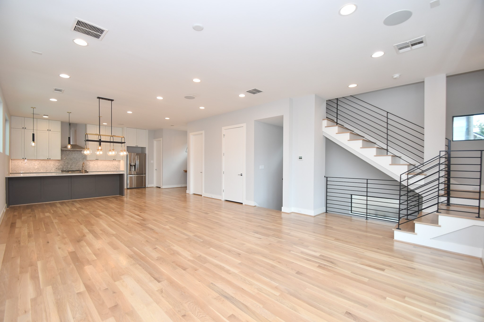 a view of kitchen with kitchen island stainless steel appliances refrigerator oven and cabinets
