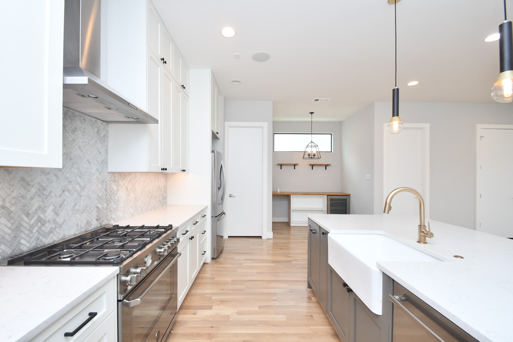 818 Knox Street Houston, TX 77007 - Photo 12 of 39 a large kitchen with stainless steel appliances a stove a sink a refrigerator and window