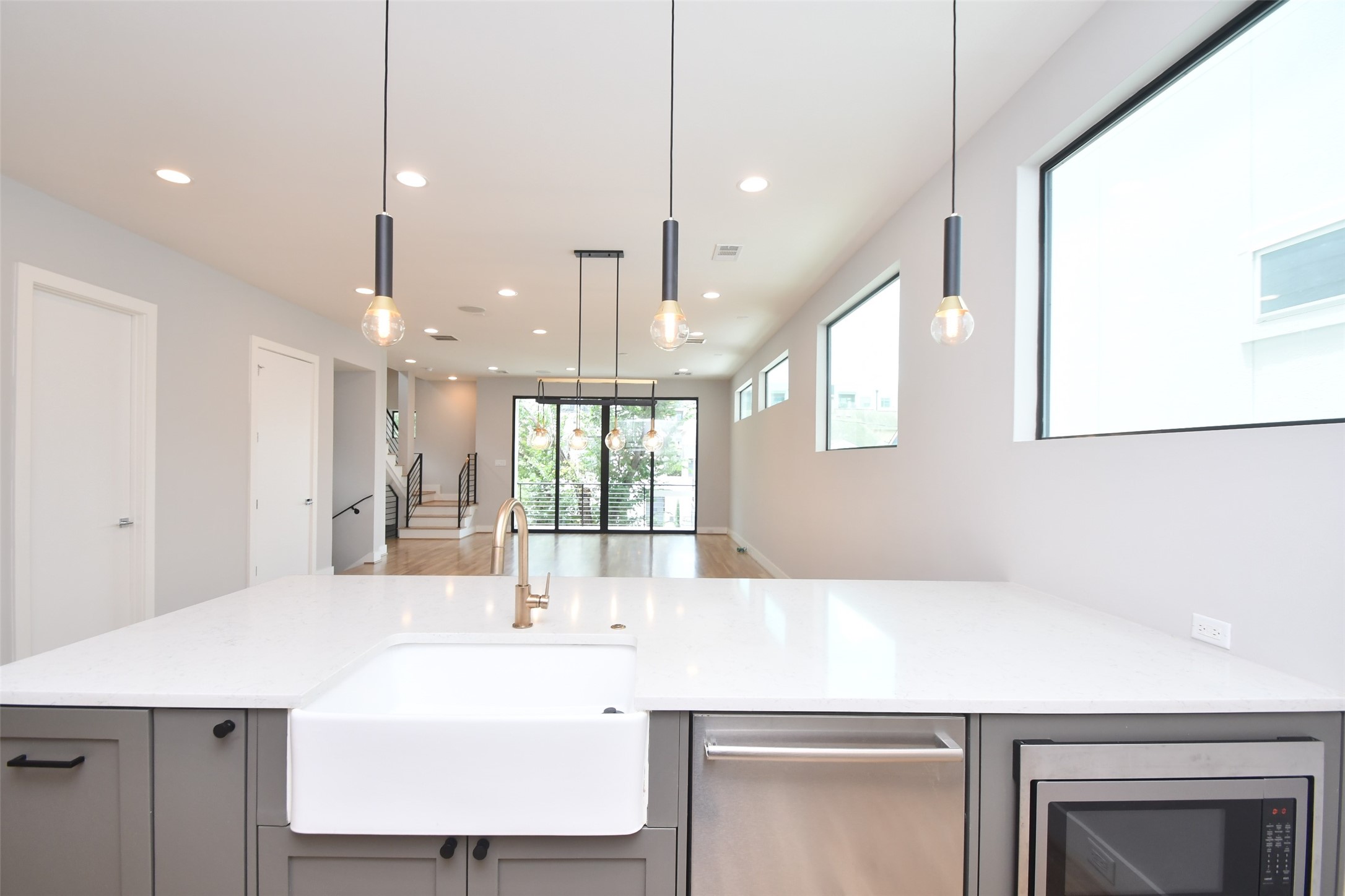 818 Knox Street Houston, TX 77007 - Photo 14 of 39 a large kitchen with kitchen island a large counter top a sink a stove and a window