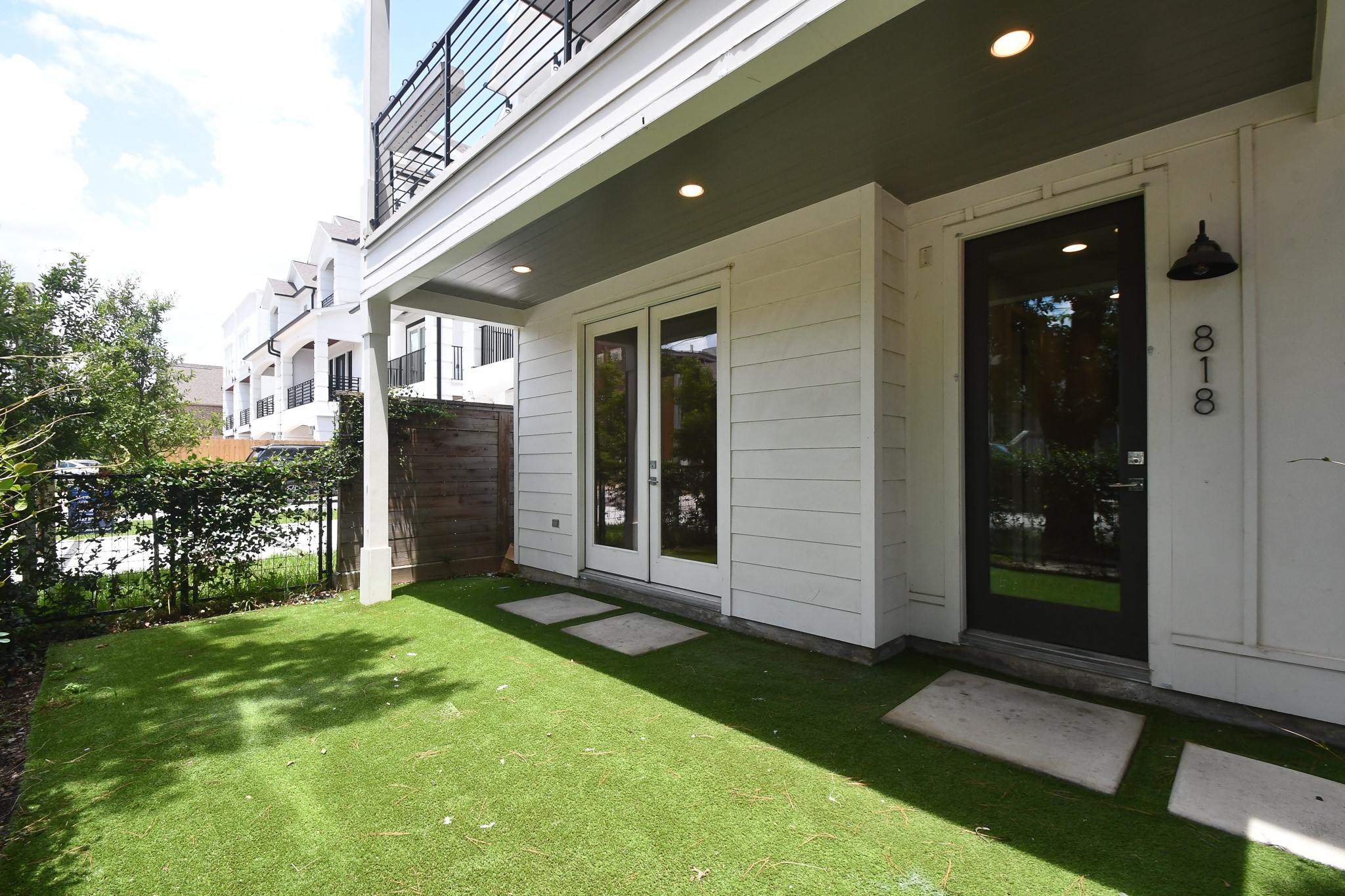 818 Knox Street Houston, TX 77007 - Photo 38 of 39 a porch with a door and a yard