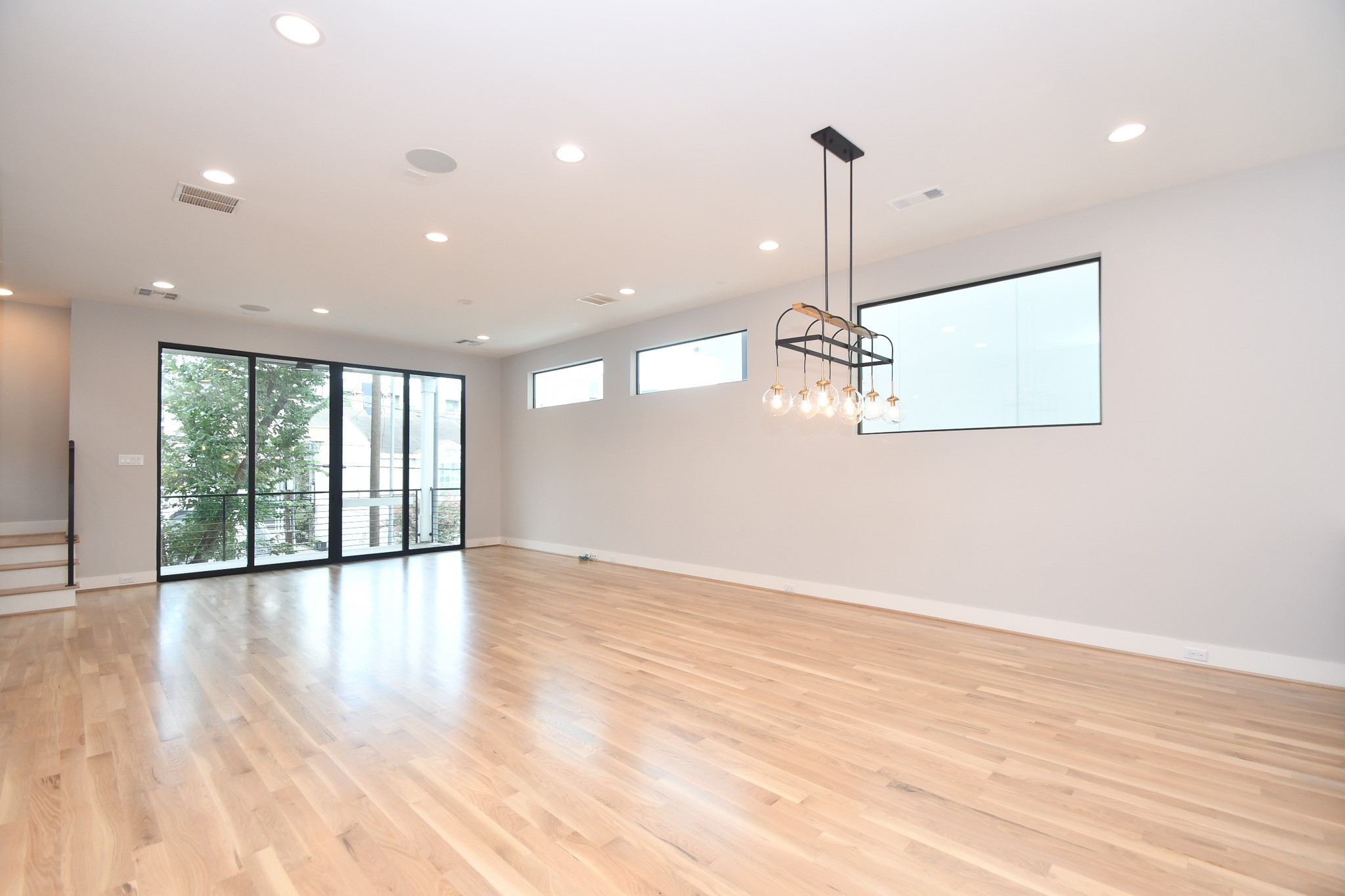 818 Knox Street Houston, TX 77007 - Photo 5 of 39 a view of an empty room with wooden floor and a window