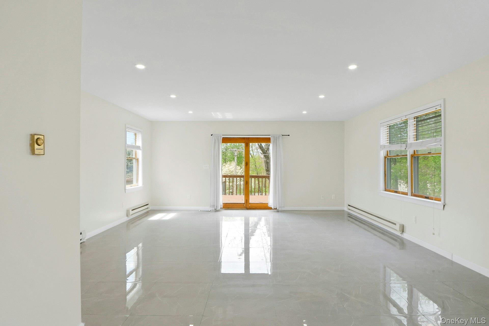 22 Firth Street, Unit 22 Cornwall, NY 12518 - Photo 17 of 42 Spacios family room with marble-stye tile and sliding door to large deck