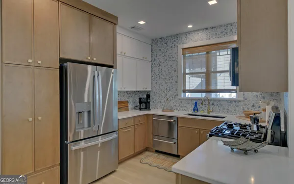 a stove top oven sitting inside of a kitchen