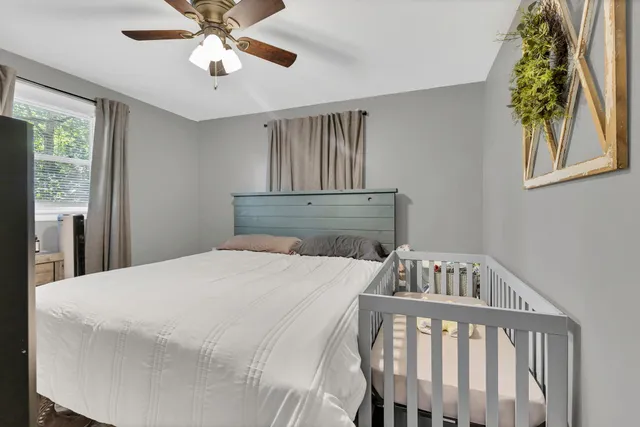 a bedroom with a bed and a chandelier